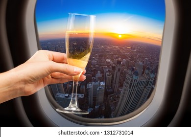 Glass of wine and Chicago view from plane window - Shutterstock ID 1312731014