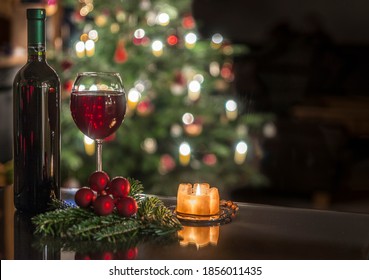 A Glass Of Wine In Front Of The Christmas Tree