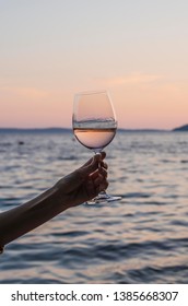 A glass of wine in her hand - Shutterstock ID 1385668307