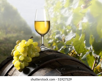 The Glass Of Wine An And Old Barrel And Grape