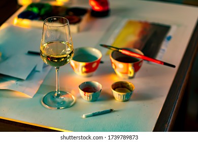 glass of wine on the artists work table
