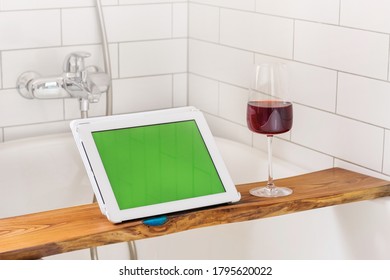 Glass Of Wine On Shelf Near Tablet With Chromakey While Relaxing In Bathtub At Home