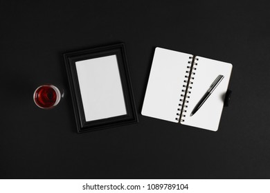 Glass of wine, photo frame and notebook on black background. - Powered by Shutterstock