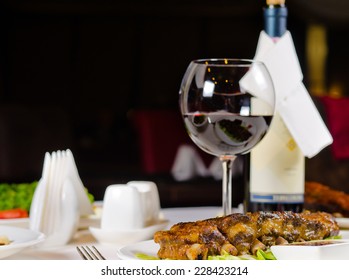 Glass of Wine Served with Grilled Pork Ribs in Restaurant