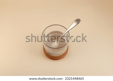 Glass of Xanthan gum dissolved in water, top view. Food additive E415. Stabiliser and Thickener. Mixture is widely used in food industry for thickening gluten-free products, pastries and beverages.