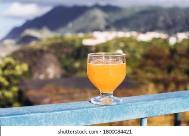 A Glass Of Yellow Drink - Traditional Alcoholic Orange Drink From Madeira - Poncha