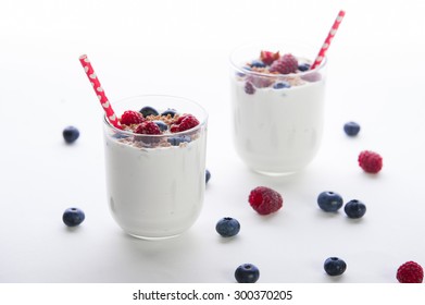 A Glass Of Yoghurt With Blueberries And Raspberries