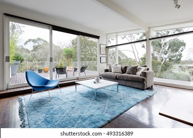 Glassed wall Australian living room with amazing views of bush treetops - Powered by Shutterstock