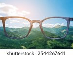 Glasses against beautiful mountain landscape. View through lenses more clear. Vision correction