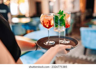 glasses alcohol cocktail set on a waiter tray in bar - Powered by Shutterstock