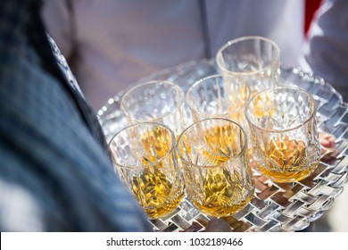 
				Glasses with alcohol on a tray