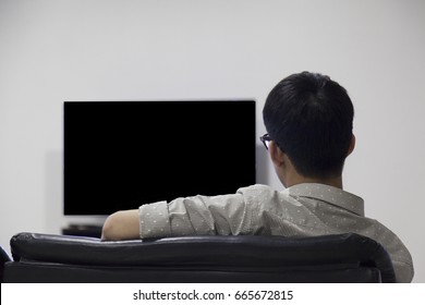 Glasses Asian Men Black Head 
 Is Watching Blank TV Television 
 For Comercial Sitting  Down On 
 Relax Black Sofa Couch