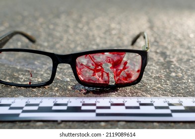 Glasses In Blood Bullet Hole. Crime Scene, Murder In The Head