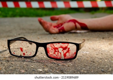 Glasses In Blood Bullet Hole. Crime Scene, Murder In The Head