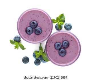 Glasses Of Blueberry Smoothie With Fresh Berries And Mint On White Background, Top View