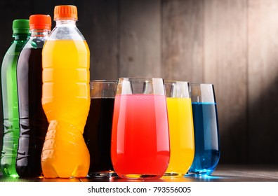 Glasses And Bottles Of Assorted Carbonated Soft Drinks In Variety Of Colors