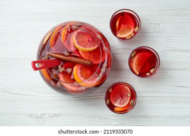 Glasses And Bowl With Aromatic Punch Drink On White Wooden Table, Flat Lay