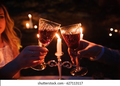 Glasses by candlelight during a dinner outdoors