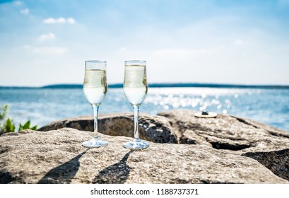 Glasses of champagne against the background of the sunny sea landscape - Powered by Shutterstock