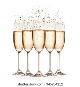 Glasses of champagne with bubbles, isolated on white background