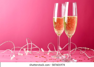 Glasses Of Champagne On Pink Background