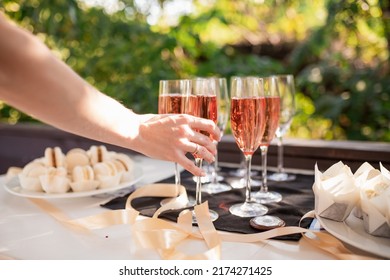 Glasses Of Champagne On Table Served For Buffet Catering Party Outdoors, Close Up. Hands Whith Glass. Selective Focus
