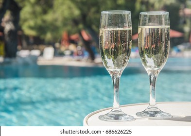 Glasses Of Champagne In The Pool