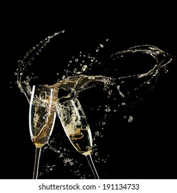 Glasses Of Champagne With Splash, On Black Background