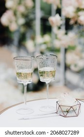 Glasses of champagne and wedding rings on the table for the bride and groom at the engagement ceremony. High quality photo