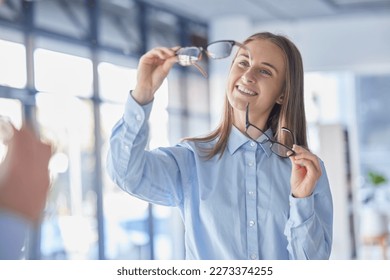 Glasses, choice and vision with a woman at the optometrist for new prescription frame lenses as a customer. Eyewear, decision and shopping with an attractive young female shopper buying eyeglasses