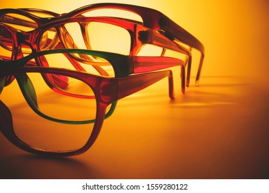 Glasses Close Up Artistic Shot. Rimmed Eyeglasses Background With Copy Space. Various Reading Glasses