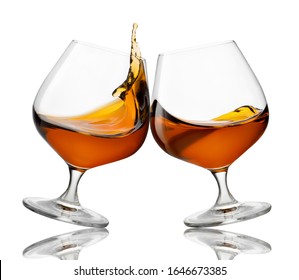 Glasses Of Cognac Making Toast With Splash Isolated On White Background