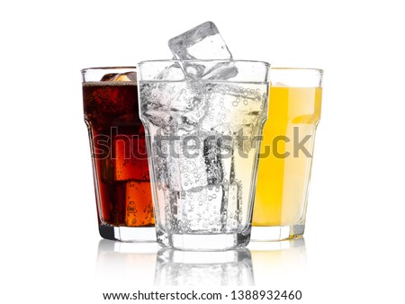 Glasses of cola and orange soda drink and lemonade sparkling water on white background with ice cubes Сток-фото © 