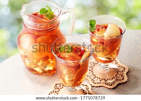 Glasses of cold ice tea with apple, ice, mint on background. Spring and summer drinks and beverages concept.