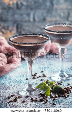 glasses of cream coffee cocktail or chocolate martini on blue background