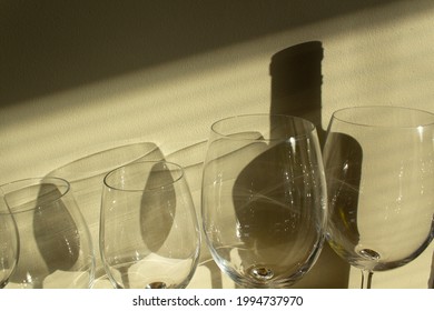 Glasses With Dark Shadows Of Wine Bottle On Sun Light Background Food And Drink Wine Degustation Concept 