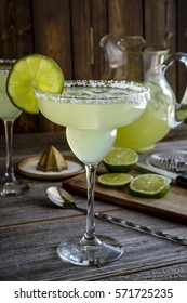 Glasses Filled With Classic Lime Margarita Cocktail With Pitcher And Fresh Lime Slices