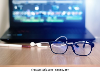 Glasses For Filtering Blue Light From The Computer.This Helps Prevent Computer Vision Syndrome.Glasses For Computer Work And Headset,Notebook,on Desk.