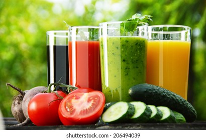 Glasses with fresh vegetable juices in the garden. Detox diet.