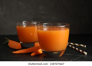 Glasses Of Freshly Made Carrot Juice On Black Table