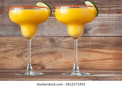 Glasses Of Frozen Mango Margarita Cocktails Garnished With Paprika Salt Rim