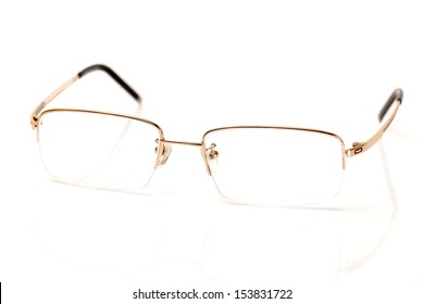 a glasses of gold color for dull sight on white background