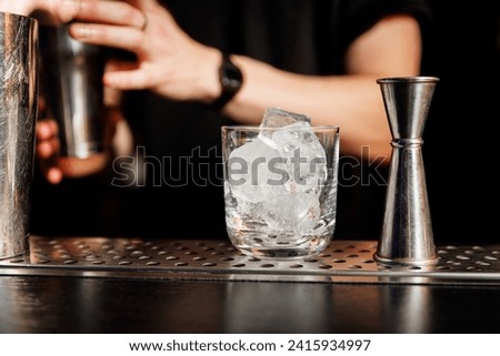 Glasses with ice while preparing an alcoholic cocktail