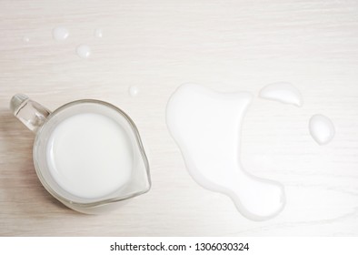 Glasses Jug Of Milk On A Wooden Background. Top View. Spilled Milk. 