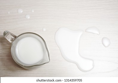 Glasses Jug Of Milk On A Wooden Background. Top View. Spilled Milk. 