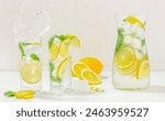 Glasses of lemonade with splash, Summer refreshing lemonade drink cocktail with ice, and lemon slices, summer concept,