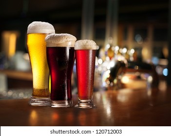 Glasses of light and dark beer on a pub counter. Beer background. - Powered by Shutterstock