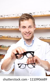 Glasses. The Man Chooses Spectacle Frames In The Optical Salon