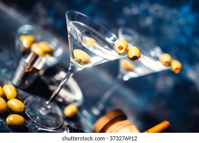 Glasses of martini with olives and vodka. Alcoholic beverages served at bar