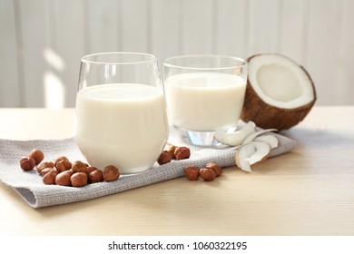 Glasses With Milk Substitute And Nuts On Kitchen Table